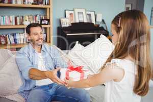 Daughter giving gift to father