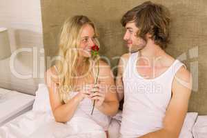 Handsome man offering a rose to his girlfriend