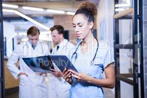 Female doctor looking at digital tablet in hospital