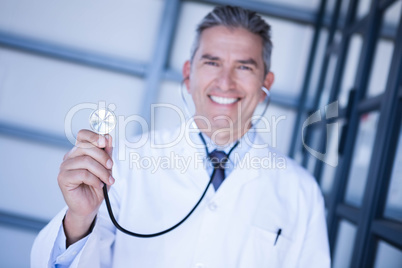 Portrait of male doctor showing stethoscope