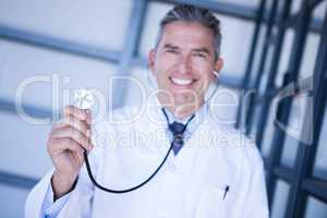 Portrait of male doctor showing stethoscope