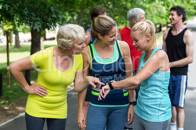Marathon female athletes setting heart rate watch