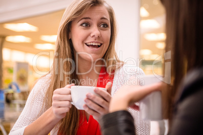 Woman talking while having coffee