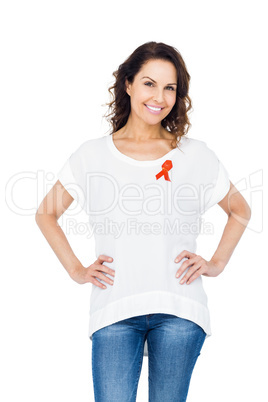 Pretty brunette wearing red aids awareness ribbon