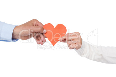 Couple holding paper heart