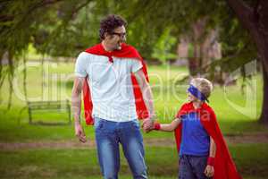 Father and son pretending to be superhero