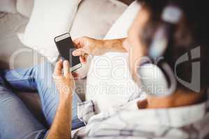 Man using mobile phone while listening music