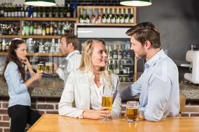 Couples looking at each other while holding beer