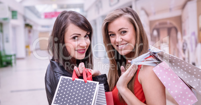 Portrait of two beautiful women shopping in mall