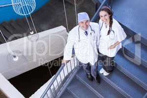 Portrait of happy doctors standing on staircase