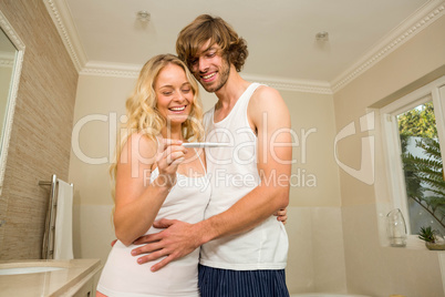 Cute couple happy to see the positive pregnancy test
