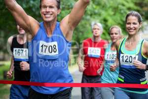 Marathon male athlete crossing the finish line