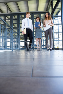 Three confident colleagues discussing in office