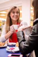 Woman talking while having coffee