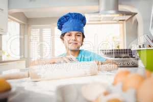 Boy smiling while preparing food at home