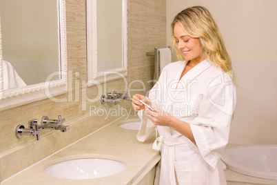 Pretty blonde woman smiling looking at pregnancy test