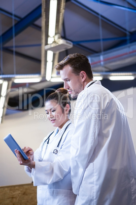 Doctors discussing over digital tablet