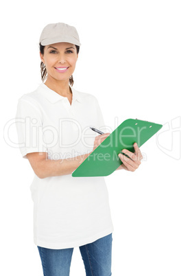 Delivery woman signing a clipboard