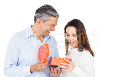 Happy couple opening present Happy couple opening present