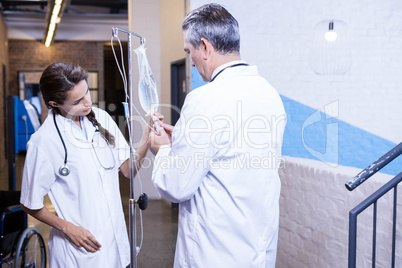 Doctors checking a saline drip