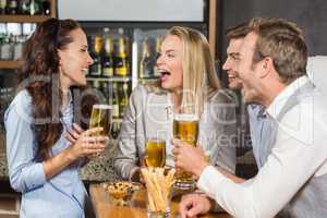Friends laughing while drinking beer