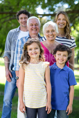 Smiling family standing in a row