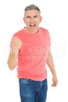 Excited man shouting with fist up