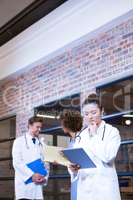 Female doctor looking at digital tablet near library