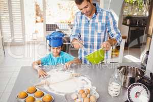 Son helping father in preparing food