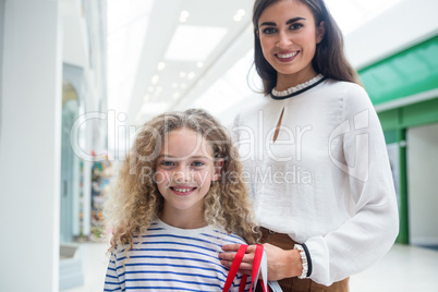 Happy mother and daughter in shopping mall