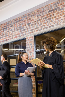Lawyer looking at documents and interacting with businesswoman