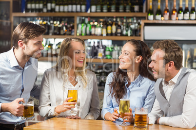 Friends talking while holding beer