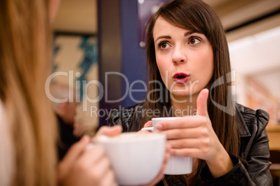 Woman talking while having coffee