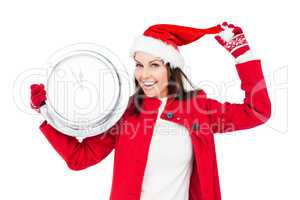 Beautiful brunette with santa hat holding a clock