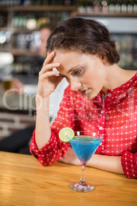 Tired woman with head in hand