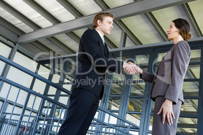 Businessman shaking hands with businesswoman Businessman shaking hands with businesswoman