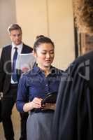 Lawyer looking at documents and interacting with businesswoman