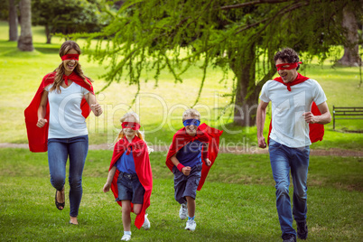 Happy family pretending to be superhero running