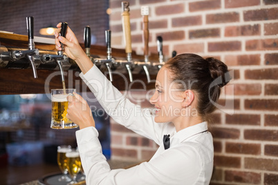 Barmaid pouring beer