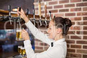 Barmaid pouring beer