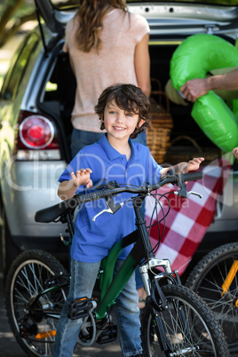 Smiling boy with his bike