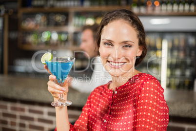 Smiling woman holding cocktail