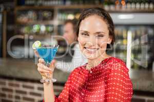 Smiling woman holding cocktail