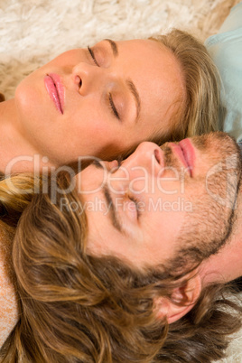 Cute couple sleeping on the carpet