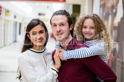 Portrait of happy family in shopping mall