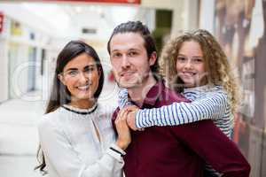 Portrait of happy family in shopping mall