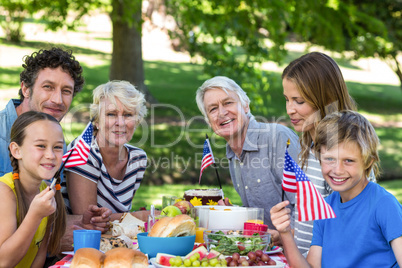 Family with American flag having a picnic