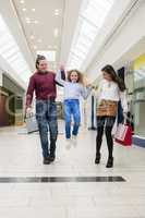 Happy family walking with shopping bags