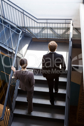 Businesspeople climbing the staircase