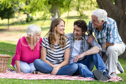 Smiling family sitting on a blanket